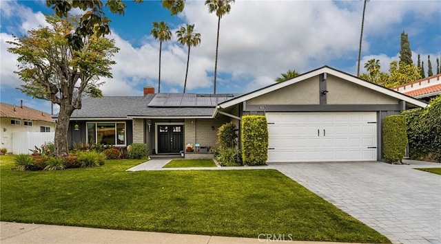 1624 Kingston Rd, Placentia, CA 92870 - single story home featuring decorative driveway, solar panels, an attached garage, a chimney, and brick siding