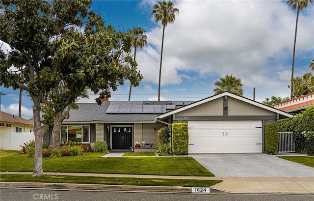 1624 Kingston Rd, Placentia, CA 92870 - ranch-style house with an attached garage, roof mounted solar panels, driveway, brick siding, and a shingled roof
