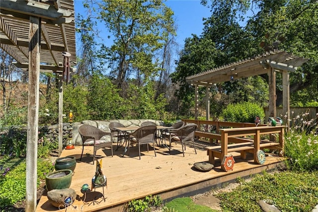 5 Sycamore Valley Rd, Chico, CA 95973 - wooden deck featuring outdoor dining space, a pergola, and view of wooded area