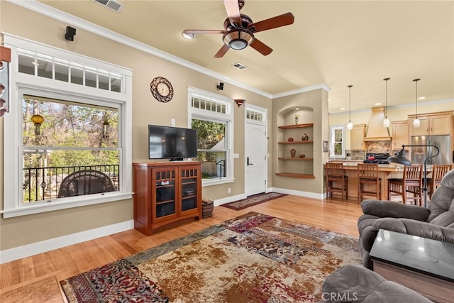 5 Sycamore Valley Rd, Chico, CA 95973 - living room featuring a ceiling fan, ornamental molding, light wood-style floors, built in features, and baseboards