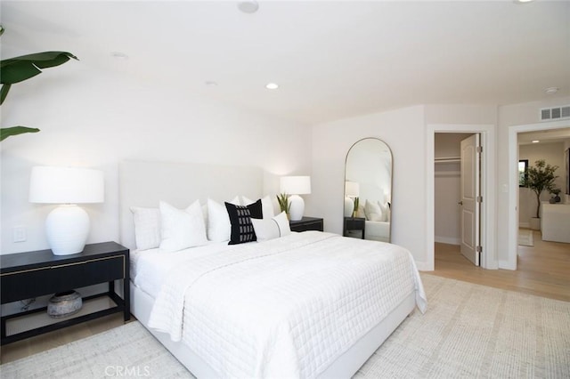 12312 Eveningside Dr, Santa Ana, CA 92705 - bedroom with a walk in closet, wood finished floors, baseboards, a closet, and recessed lighting