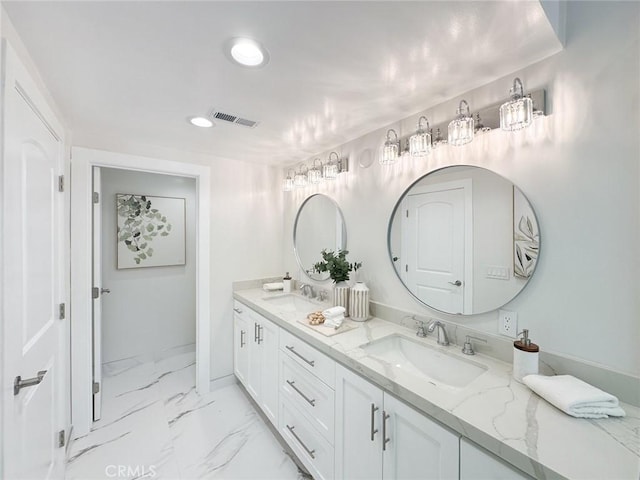 12312 Eveningside Dr, Santa Ana, CA 92705 - bathroom with double vanity, recessed lighting, marble finish floors, and baseboards