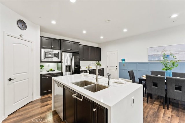 2974 E Walking Beam Pl, Brea, CA 92821 - kitchen with stainless steel appliances, a sink, dark wood finished floors, an island with sink, and light countertops