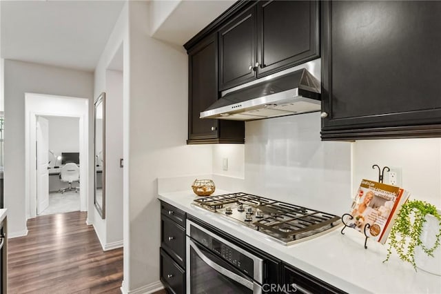 2974 E Walking Beam Pl, Brea, CA 92821 - kitchen featuring appliances with stainless steel finishes, under cabinet range hood, light countertops, dark cabinetry, and dark wood-style flooring