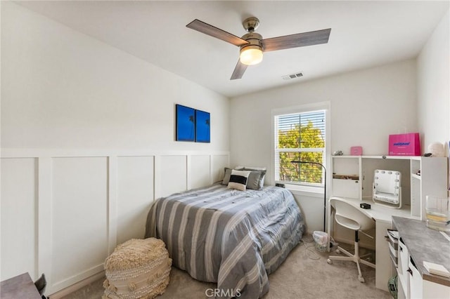 2974 E Walking Beam Pl, Brea, CA 92821 - bedroom featuring light colored carpet, a wainscoted wall, an office area, a ceiling fan, and a decorative wall