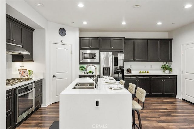 2974 E Walking Beam Pl, Brea, CA 92821 - kitchen with stainless steel appliances, a sink, under cabinet range hood, dark wood-type flooring, and light countertops
