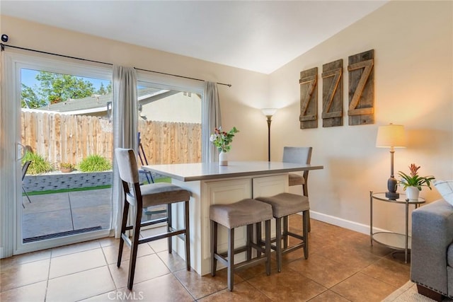 2637 Alder Creek Dr, Ontario, CA 91761 - dining area with light tile patterned floors, baseboards, and lofted ceiling