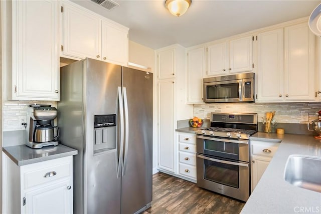 2637 Alder Creek Dr, Ontario, CA 91761 - kitchen with appliances with stainless steel finishes, dark wood finished floors, white cabinets, and backsplash