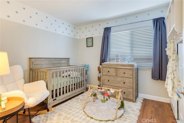 2637 Alder Creek Dr, Ontario, CA 91761 - bedroom featuring wood finished floors, baseboards, and a crib