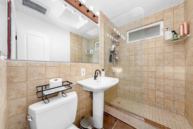 3117 Cherimoya St, Jamul, CA 91935 - full bathroom with a tile shower, toilet, tile walls, a sink, and tile patterned flooring