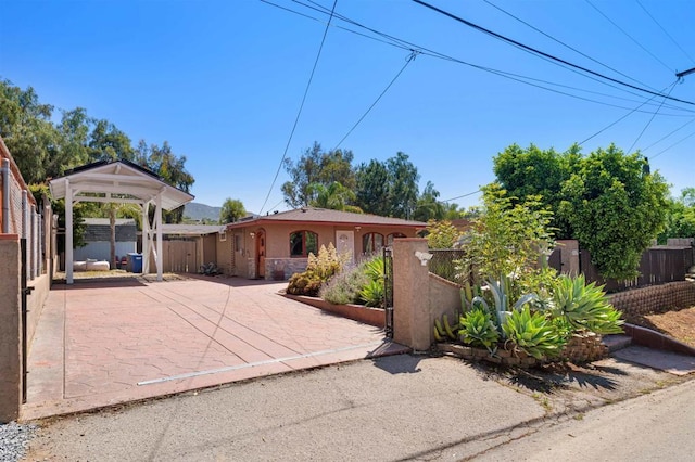 3117 Cherimoya St, Jamul, CA 91935 - view of front of home with a fenced front yard, stucco siding, a gazebo, and a gate