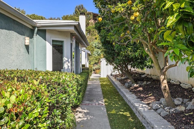 6804 Urubu St, Carlsbad, CA 92009 - view of property exterior featuring stucco siding and a chimney
