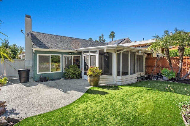 6804 Urubu St, Carlsbad, CA 92009 - back of house featuring a chimney, roof with shingles, a sunroom, and a patio area