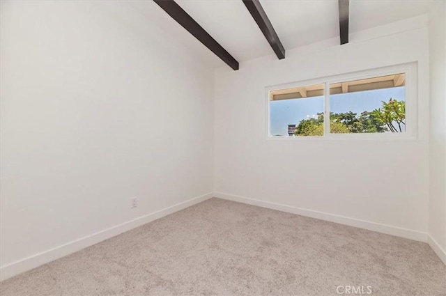 unfurnished room featuring carpet floors, beam ceiling, and baseboards