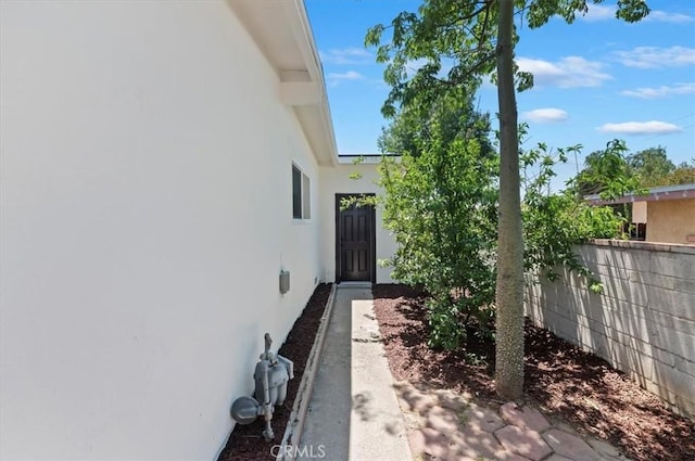 property entrance with stucco siding
