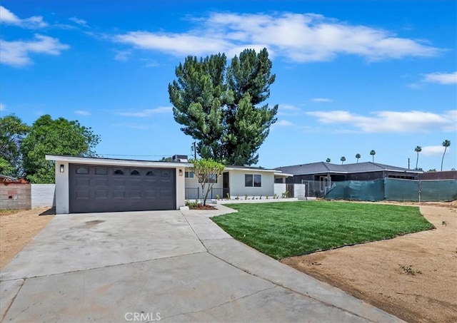 ranch-style home featuring an attached garage, concrete driveway, and stucco siding