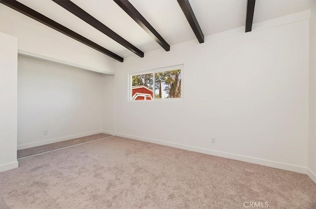carpeted empty room with baseboards