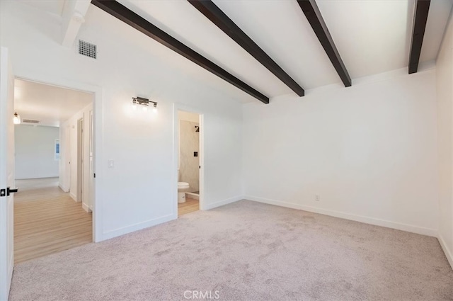 unfurnished room featuring beam ceiling, carpet flooring, and baseboards