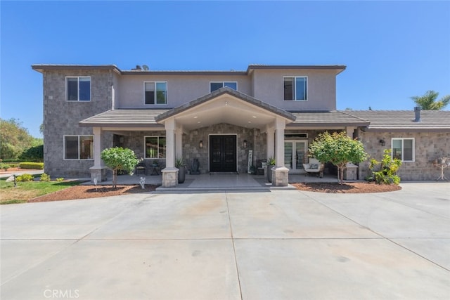 38855 Bella Vista Rd, Temecula, CA 92592 - view of front of property featuring stone siding, stucco siding, a porch, and driveway