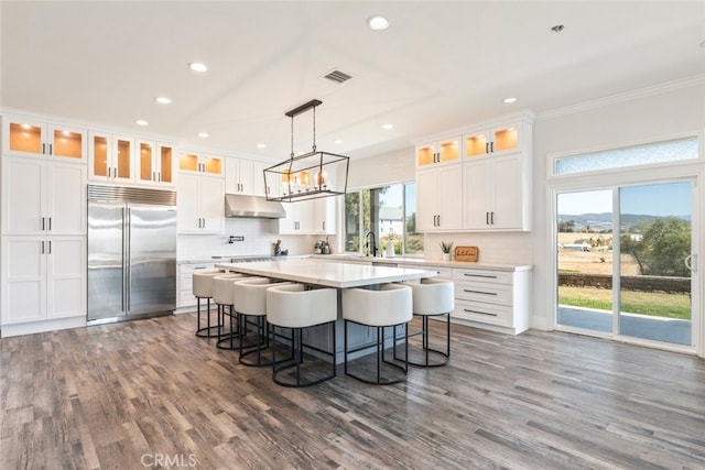 38855 Bella Vista Rd, Temecula, CA 92592 - kitchen with built in refrigerator, under cabinet range hood, decorative backsplash, a kitchen island, and recessed lighting