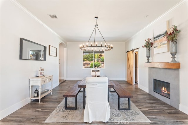 38855 Bella Vista Rd, Temecula, CA 92592 - dining room with a barn door, dark wood-style flooring, a chandelier, ornamental molding, and arched walkways
