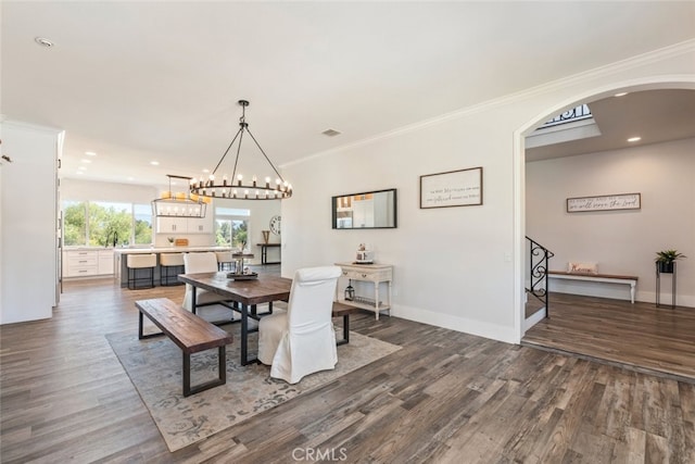 38855 Bella Vista Rd, Temecula, CA 92592 - dining room featuring arched walkways, dark wood-style flooring, recessed lighting, baseboards, and ornamental molding