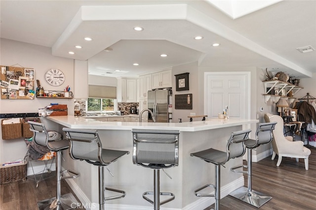 38855 Bella Vista Rd, Temecula, CA 92592 - kitchen with stainless steel refrigerator with ice dispenser, dark wood-style floors, recessed lighting, a peninsula, and a breakfast bar area