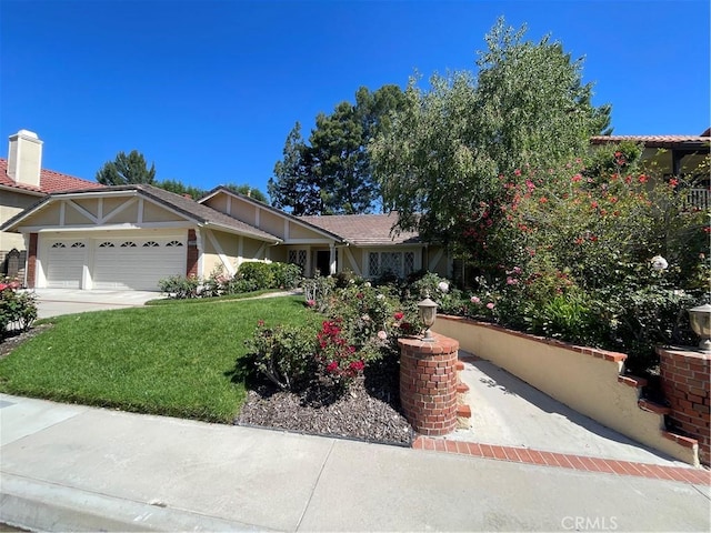 view of front of house with a garage, a front yard, stucco siding, a chimney, and concrete driveway