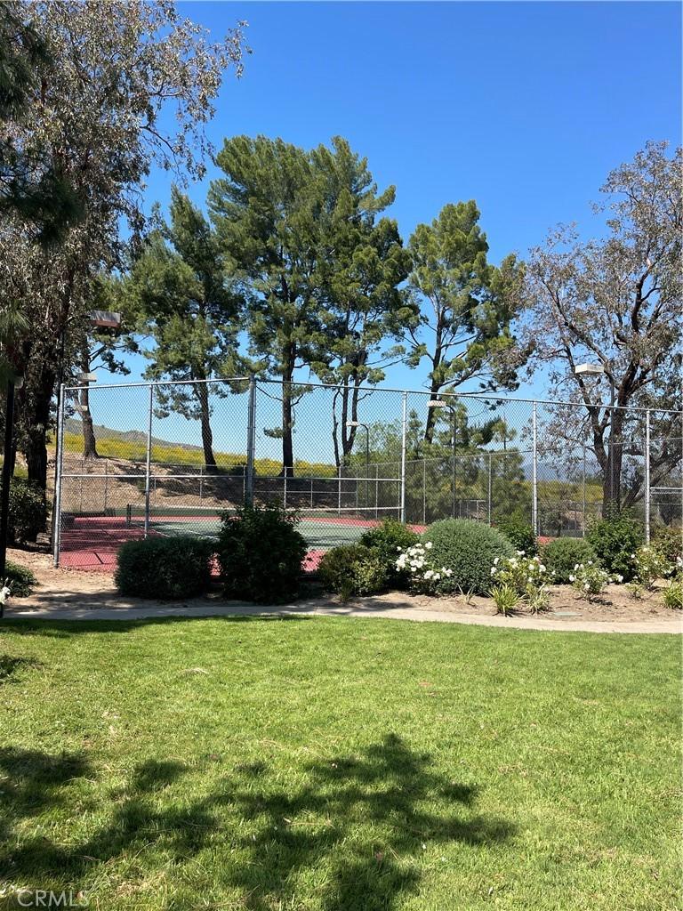 view of yard featuring a tennis court