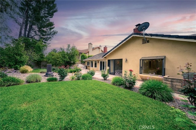 18337 Chatham Ln, Porter Ranch, CA 91326 - view of green lawn with a patio