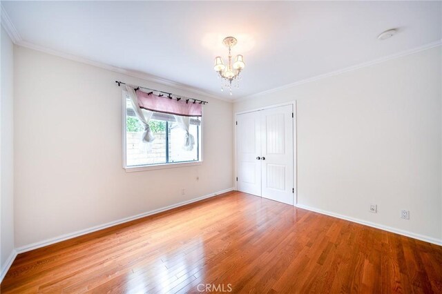 18337 Chatham Ln, Porter Ranch, CA 91326 - unfurnished bedroom featuring a chandelier, wood finished floors, a closet, and ornamental molding