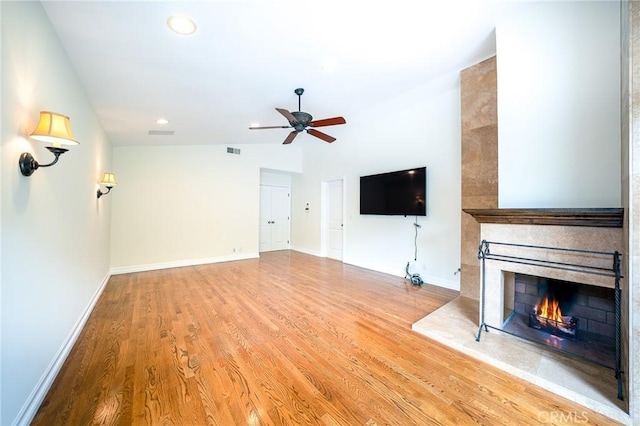 18337 Chatham Ln, Porter Ranch, CA 91326 - unfurnished living room featuring wood finished floors, a ceiling fan, a large fireplace, recessed lighting, and vaulted ceiling