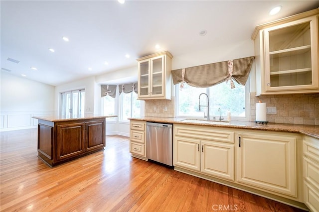 18337 Chatham Ln, Porter Ranch, CA 91326 - kitchen featuring stainless steel dishwasher, light wood-type flooring, light stone counters, wainscoting, and backsplash