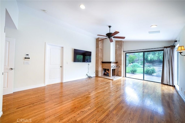18337 Chatham Ln, Porter Ranch, CA 91326 - unfurnished living room featuring vaulted ceiling, a ceiling fan, wood finished floors, a large fireplace, and recessed lighting