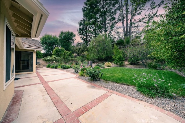 18337 Chatham Ln, Porter Ranch, CA 91326 - patio terrace at dusk featuring a patio area and a lawn