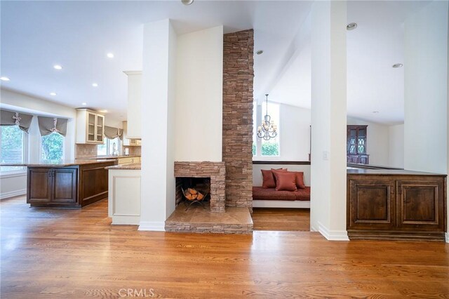 18337 Chatham Ln, Porter Ranch, CA 91326 - living room featuring wood finished floors, a fireplace, recessed lighting, vaulted ceiling, and a chandelier