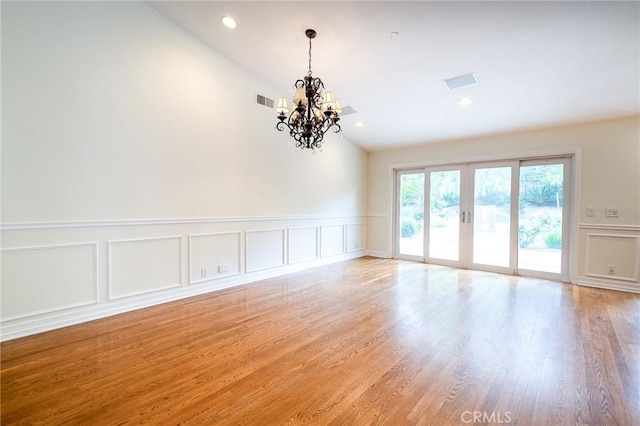 18337 Chatham Ln, Porter Ranch, CA 91326 - spare room with vaulted ceiling, a decorative wall, a chandelier, french doors, and wainscoting