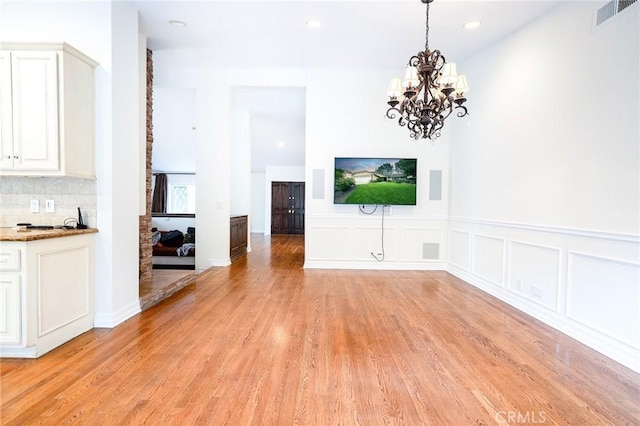 18337 Chatham Ln, Porter Ranch, CA 91326 - unfurnished dining area with a chandelier, light wood-type flooring, recessed lighting, and a wainscoted wall