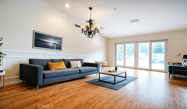 18337 Chatham Ln, Porter Ranch, CA 91326 - living area with lofted ceiling, a wainscoted wall, wood finished floors, a chandelier, and a decorative wall