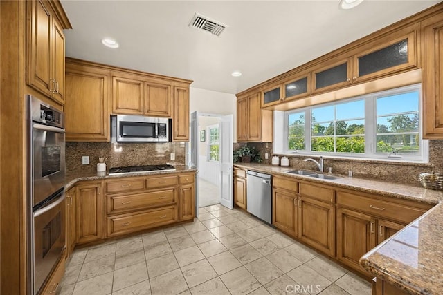 468 Gerona Ave, San Gabriel, CA 91775 - kitchen featuring stainless steel appliances, a sink, tasteful backsplash, brown cabinetry, and recessed lighting