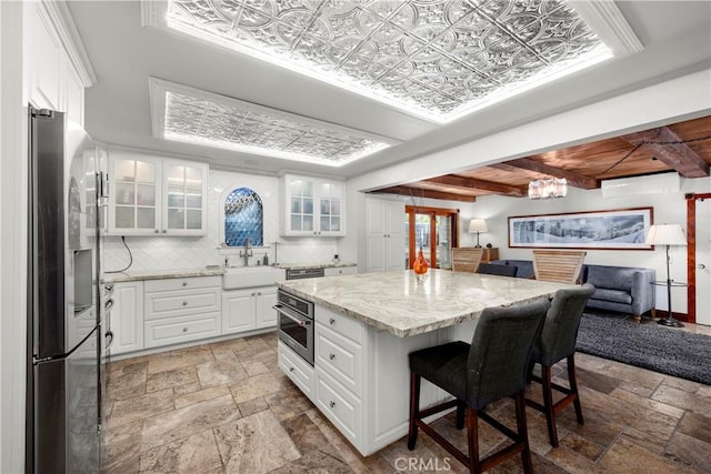 1961 Forester Creek Rd, El Cajon, CA 92021 - kitchen with appliances with stainless steel finishes, a sink, stone tile flooring, and light stone counters