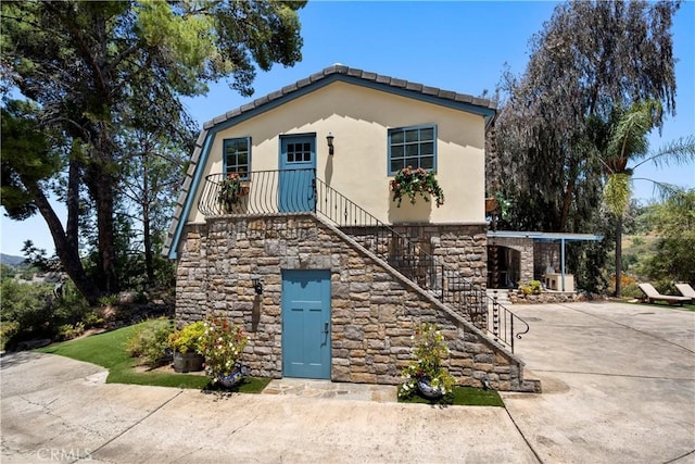 1961 Forester Creek Rd, El Cajon, CA 92021 - view of front of house with stone siding, stairway, and stucco siding