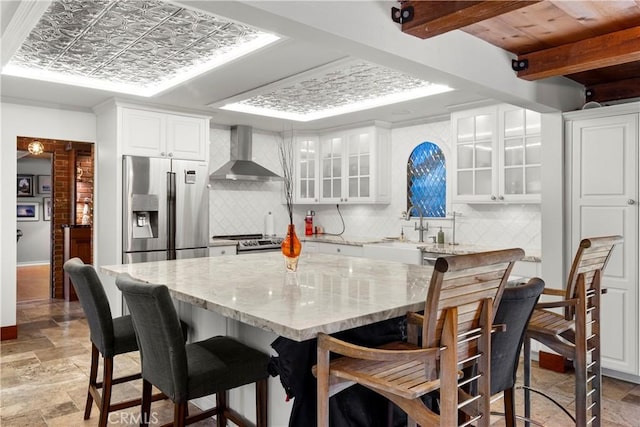 1961 Forester Creek Rd, El Cajon, CA 92021 - kitchen featuring wall chimney exhaust hood, appliances with stainless steel finishes, backsplash, glass insert cabinets, and beamed ceiling