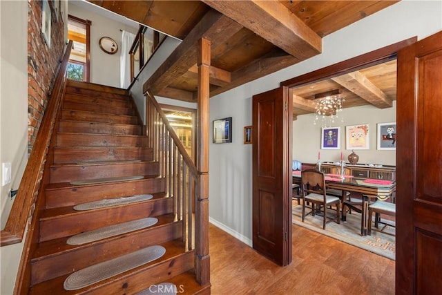 1961 Forester Creek Rd, El Cajon, CA 92021 - stairway featuring wood finished floors, a chandelier, baseboards, and wooden ceiling with exposed beams