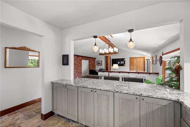 1961 Forester Creek Rd, El Cajon, CA 92021 - kitchen with gray cabinetry, baseboards, stone tile flooring, decorative light fixtures, and light stone counters