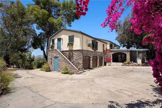 1961 Forester Creek Rd, El Cajon, CA 92021 - view of front of home with stone siding, a garage, stucco siding, and driveway