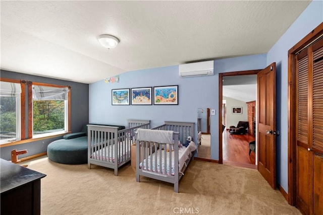1961 Forester Creek Rd, El Cajon, CA 92021 - carpeted bedroom with a wall mounted air conditioner, vaulted ceiling, a closet, and baseboards