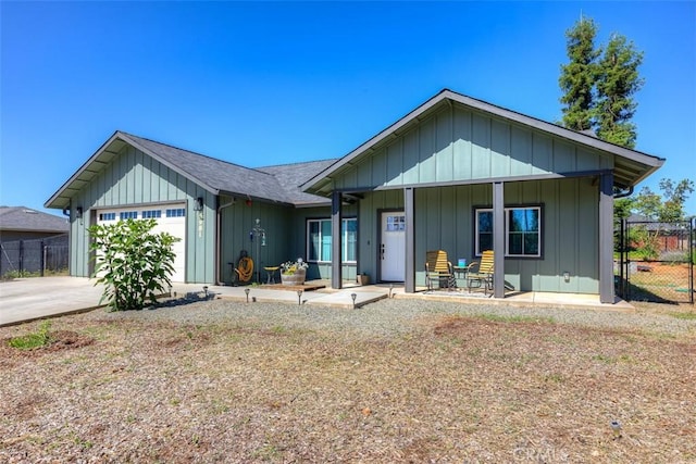 5981 Kibler Rd, Paradise, CA 95969 - ranch-style house with an attached garage, a porch, board and batten siding, and concrete driveway
