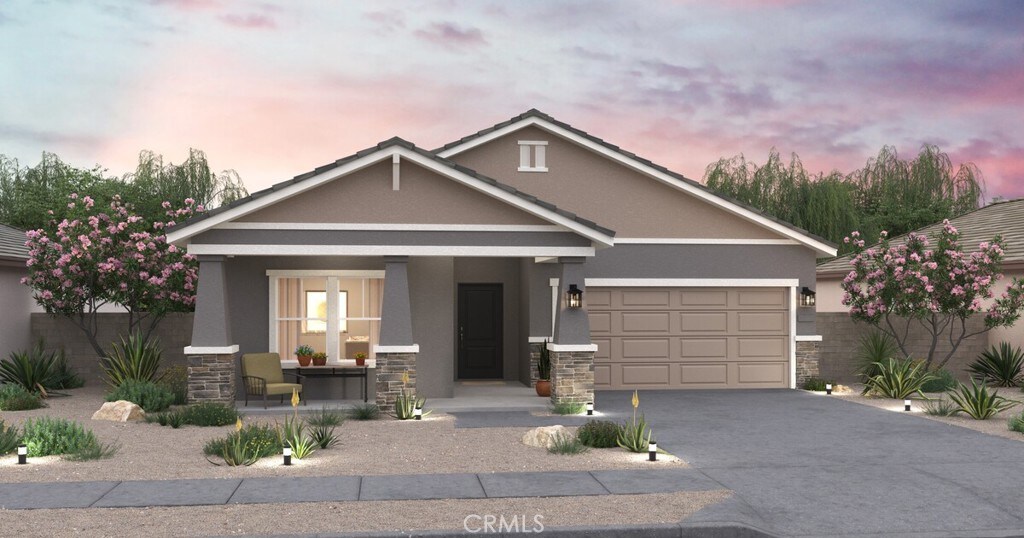 3383 Poplar St, Rosamond, CA 93560 - view of front facade with a porch, stone siding, stucco siding, driveway, and a garage