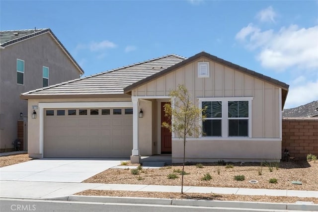 30773 Vera Cruz Cir, Winchester, CA 92596 - view of front of home featuring an attached garage, driveway, board and batten siding, and a tile roof